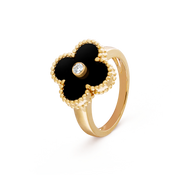 Gold ring with black flower design and diamond on a transparent background