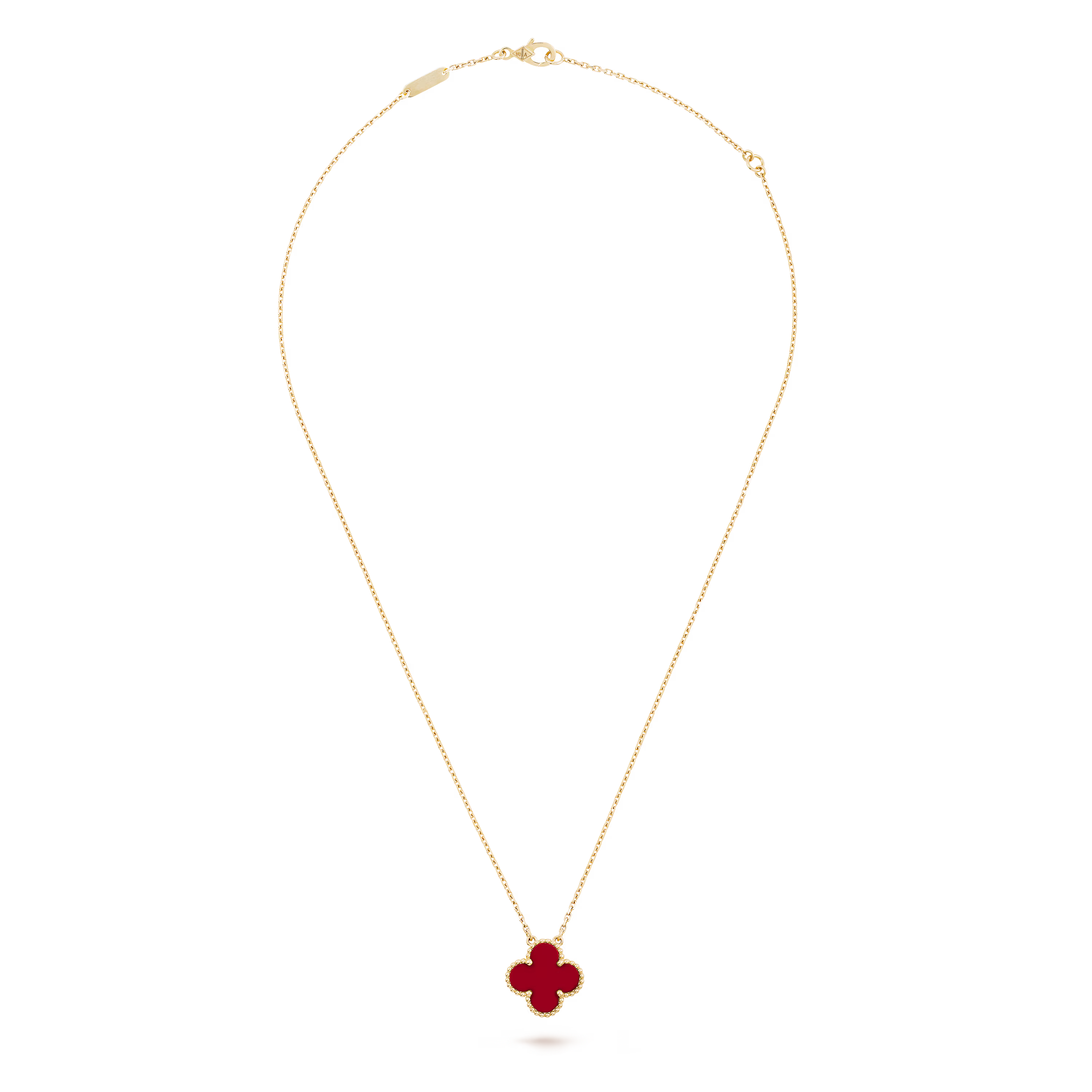 Gold necklace with a red clover pendant on a black background