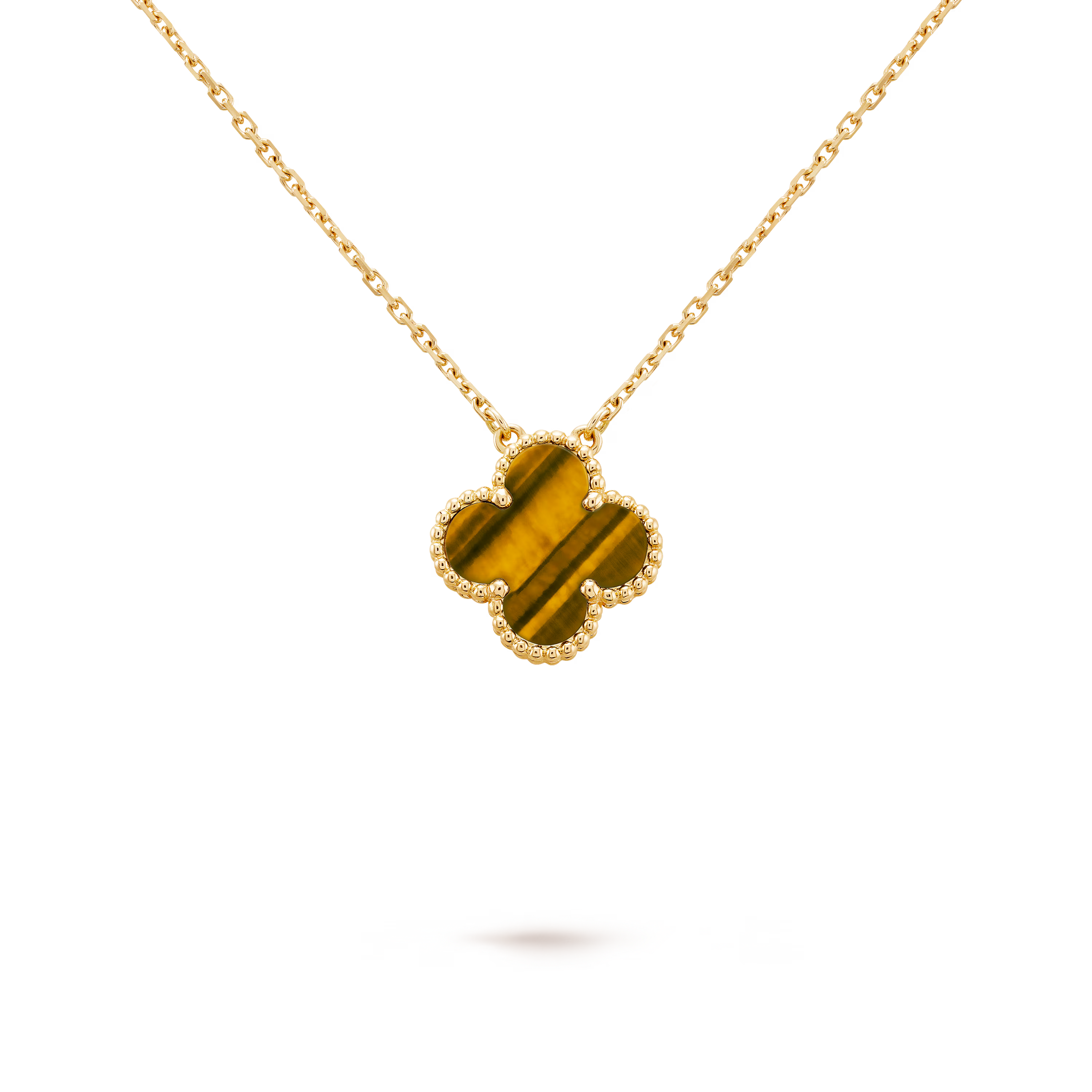 Gold necklace with a clover-shaped pendant on a black background