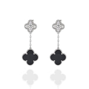 Front view of drop earrings with moissanite floral studs and black onyx clover pendants
