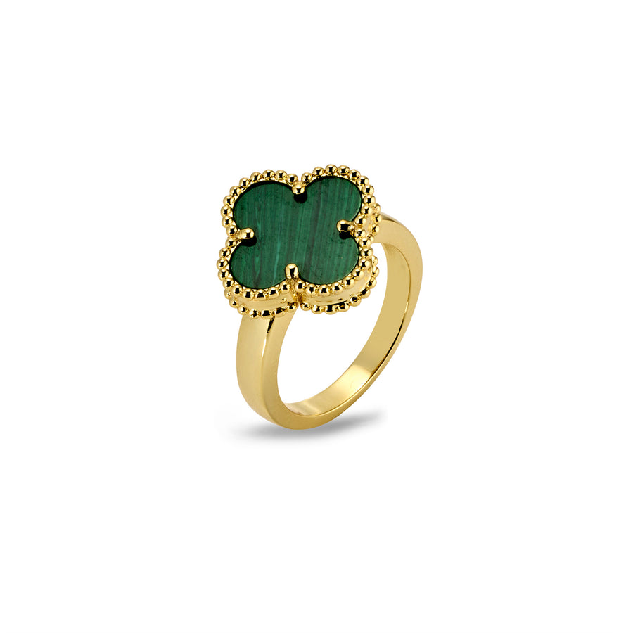 Angled view of clover-shaped ring with green inlay and textured beaded gold frame