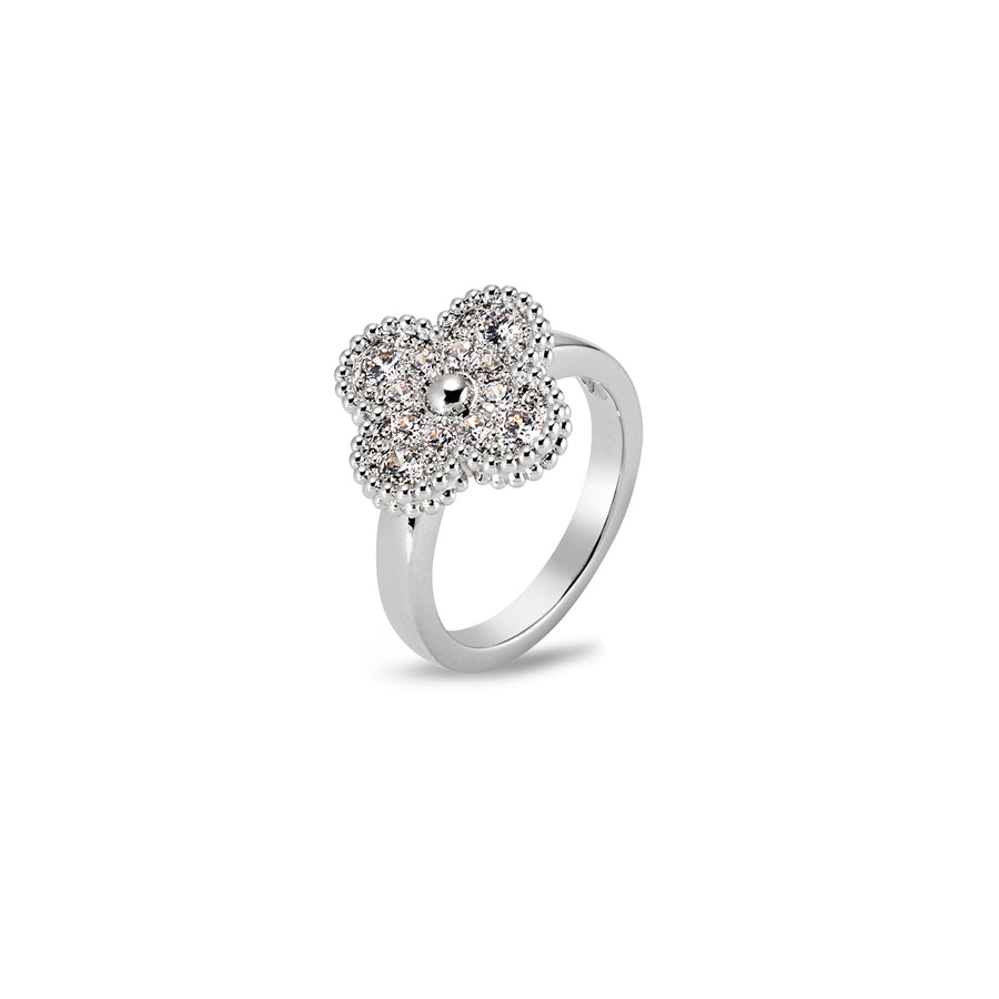 Close-up of moissanite clover ring showing sparkle and raised floral setting