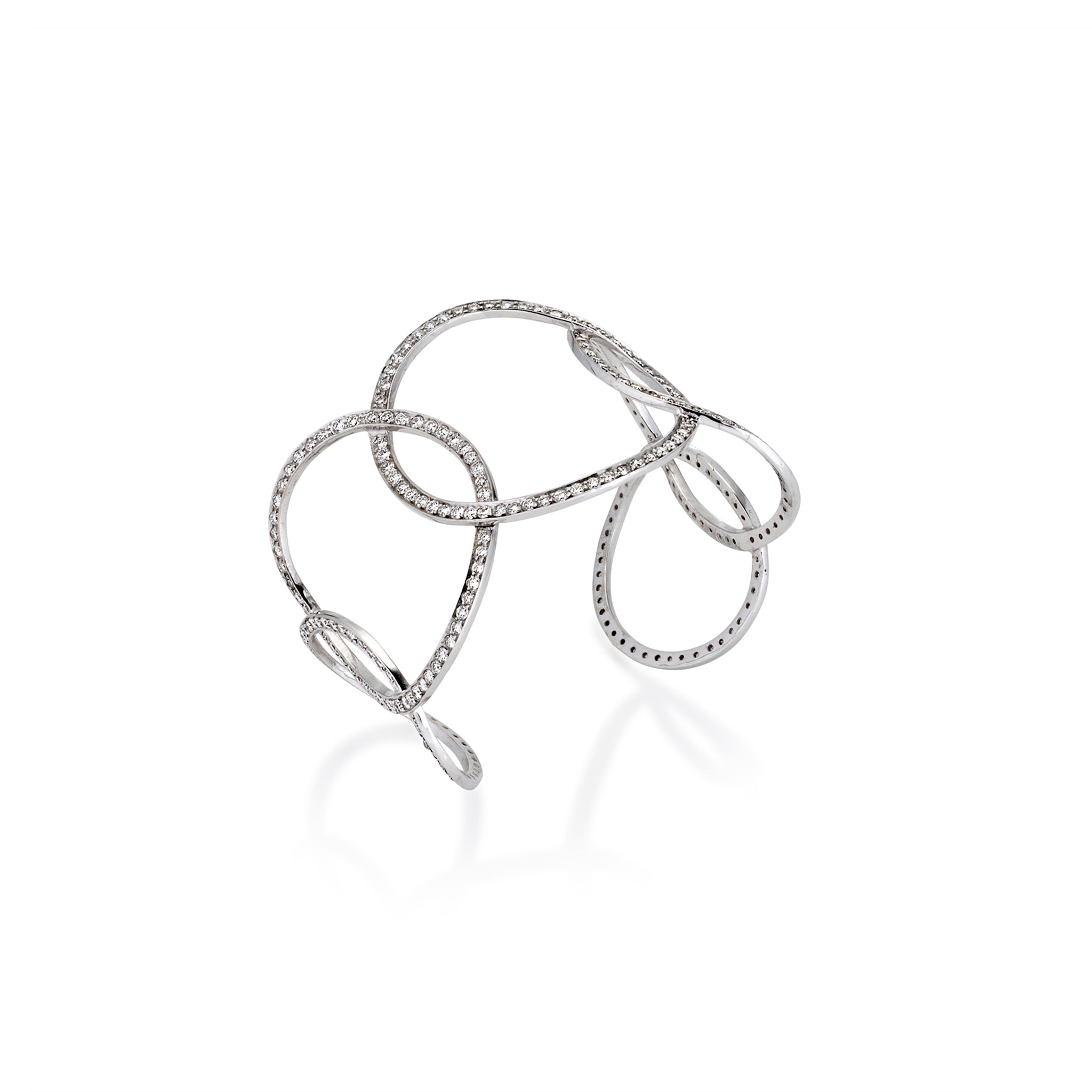 Angled view of sculptural openwork cuff bracelet with sparkling pavé moissanite