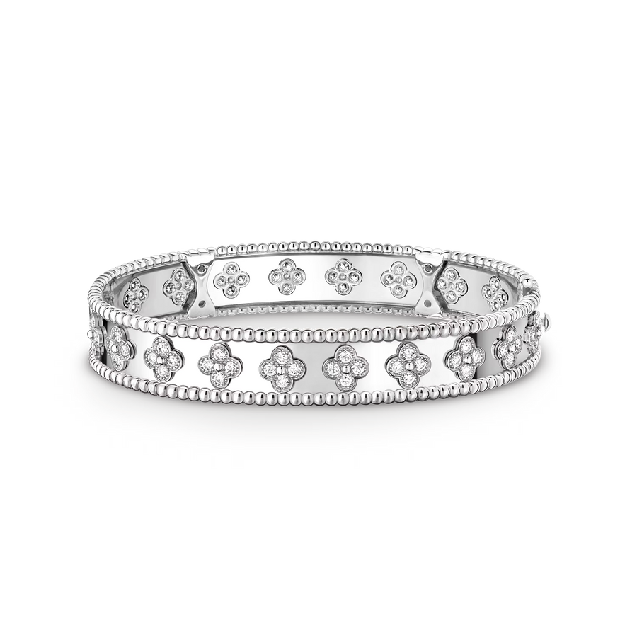 Silver bracelet with floral designs on a black background