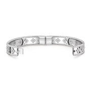 Silver bracelet with intricate designs on a white background
