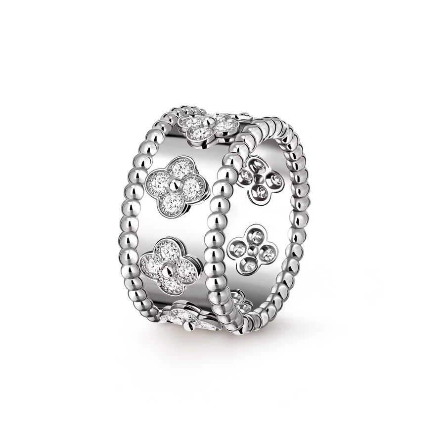 Silver ring with floral designs on a white background