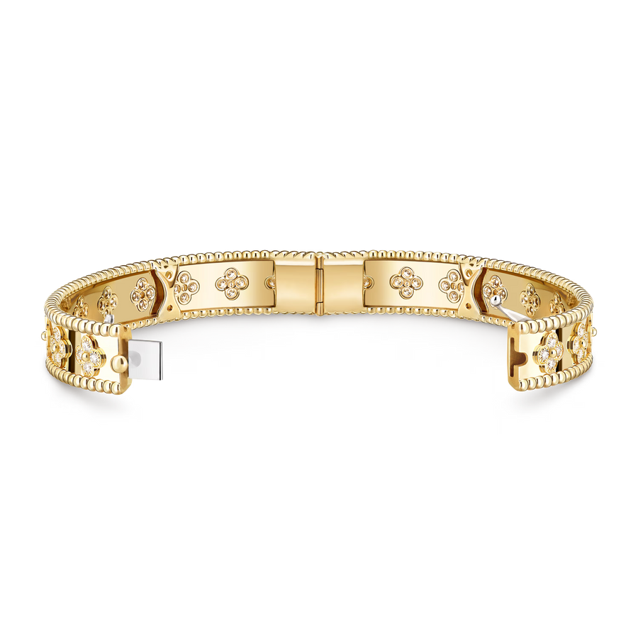 Gold bracelet with intricate designs on a white background