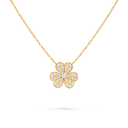 Gold necklace with a clover-shaped pendant on a black background
