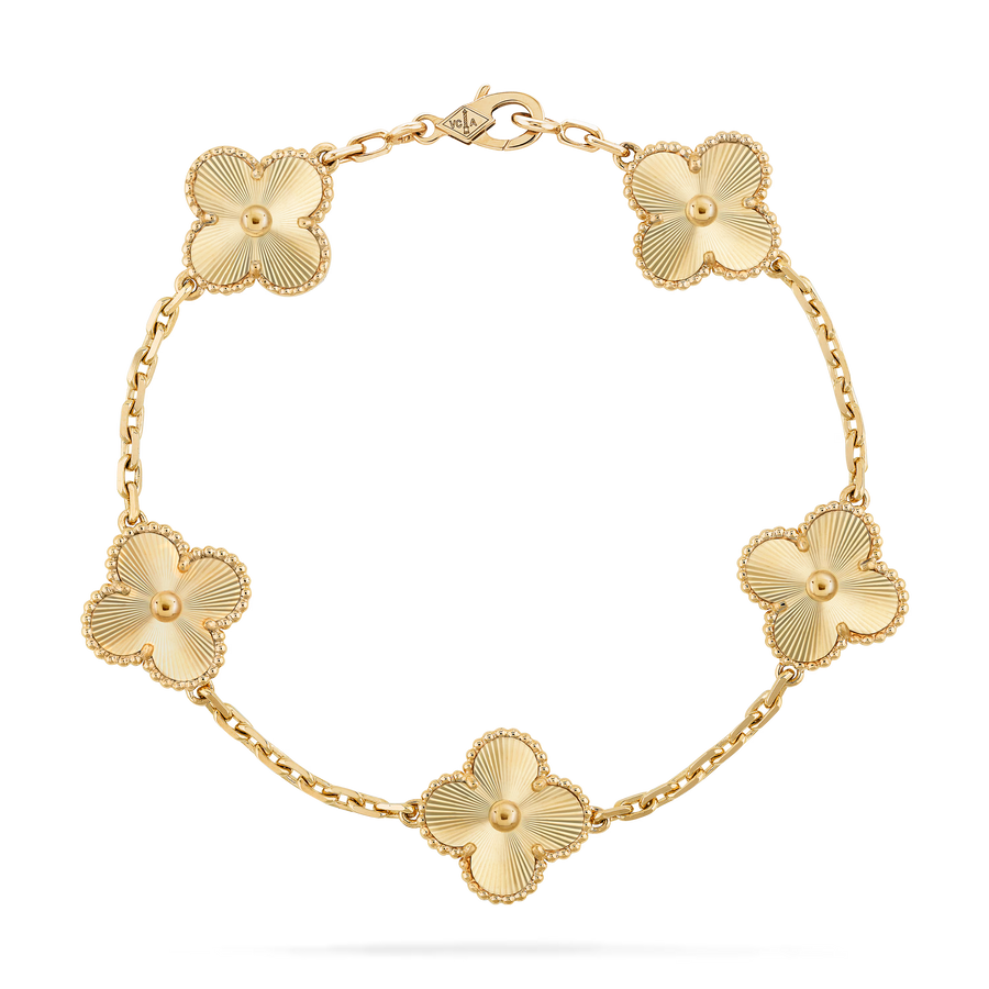 Gold bracelet with floral designs on a clear background