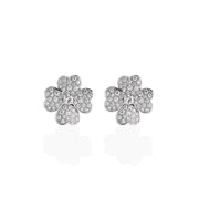 A front view of large heart-flower earrings with sparkling pavé moissanite stones in a symmetrical floral pattern.