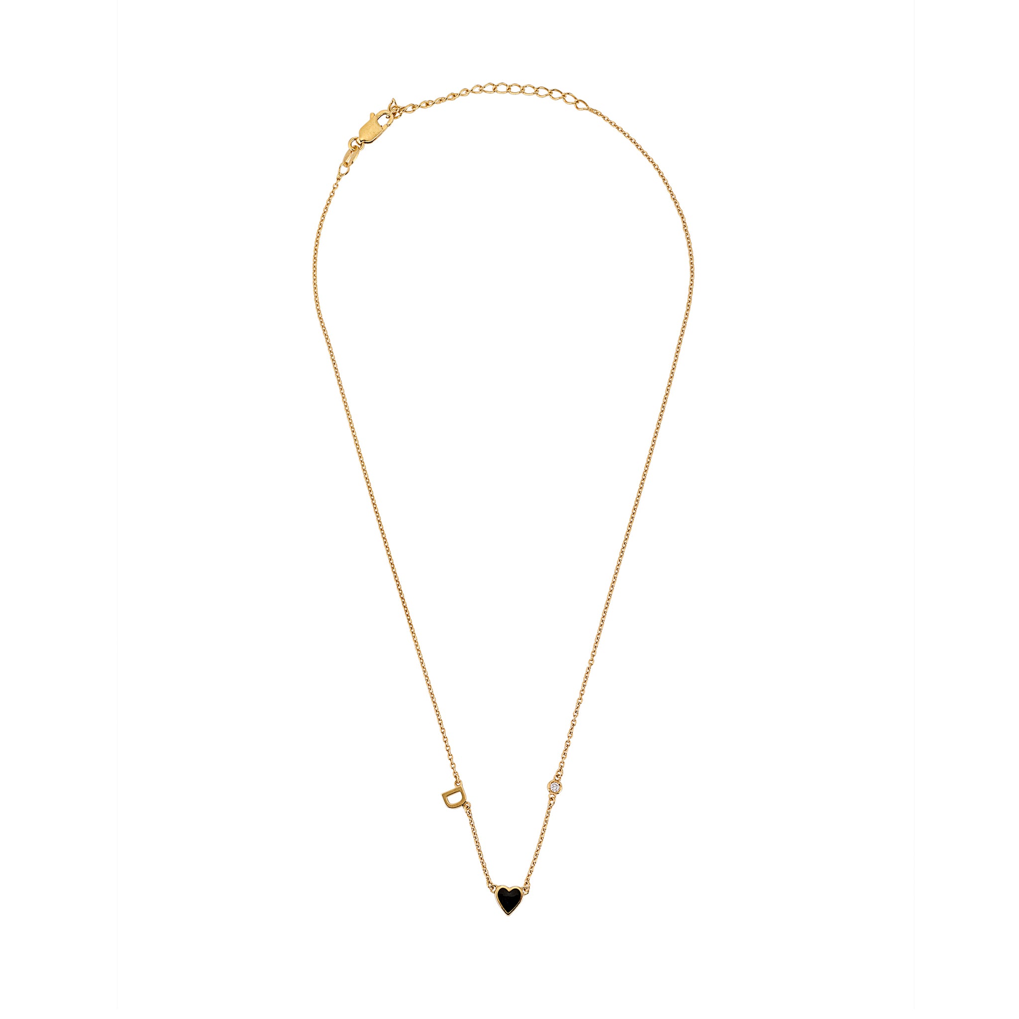 Full-length view of gold necklace with black heart charm, initial, and small decorative accents