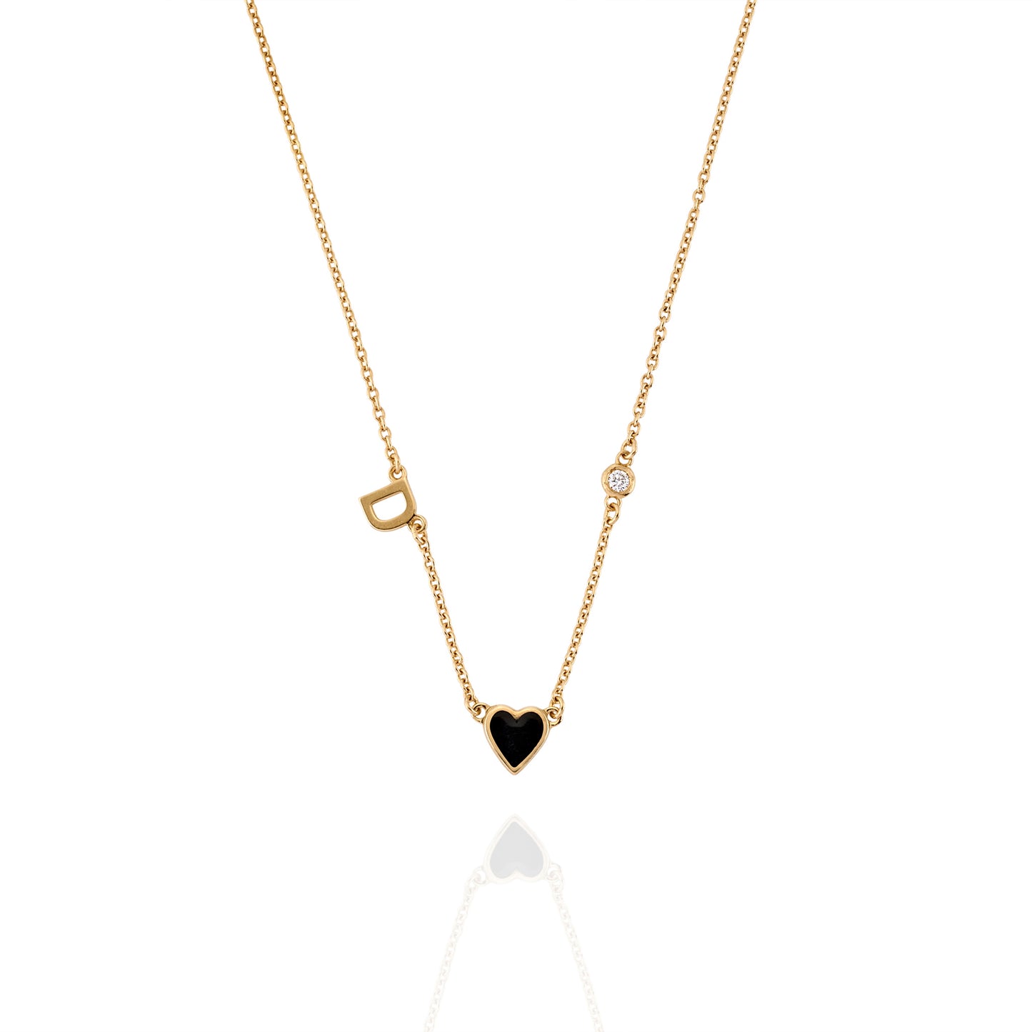 Close-up of Initial Heart Necklace with black heart centerpiece, engraved round charm, and sparkling detail