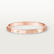 Rose gold bracelet on a light gray background