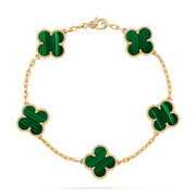 Top-down view of gold clover bracelet featuring five green malachite inlays and beaded trim
