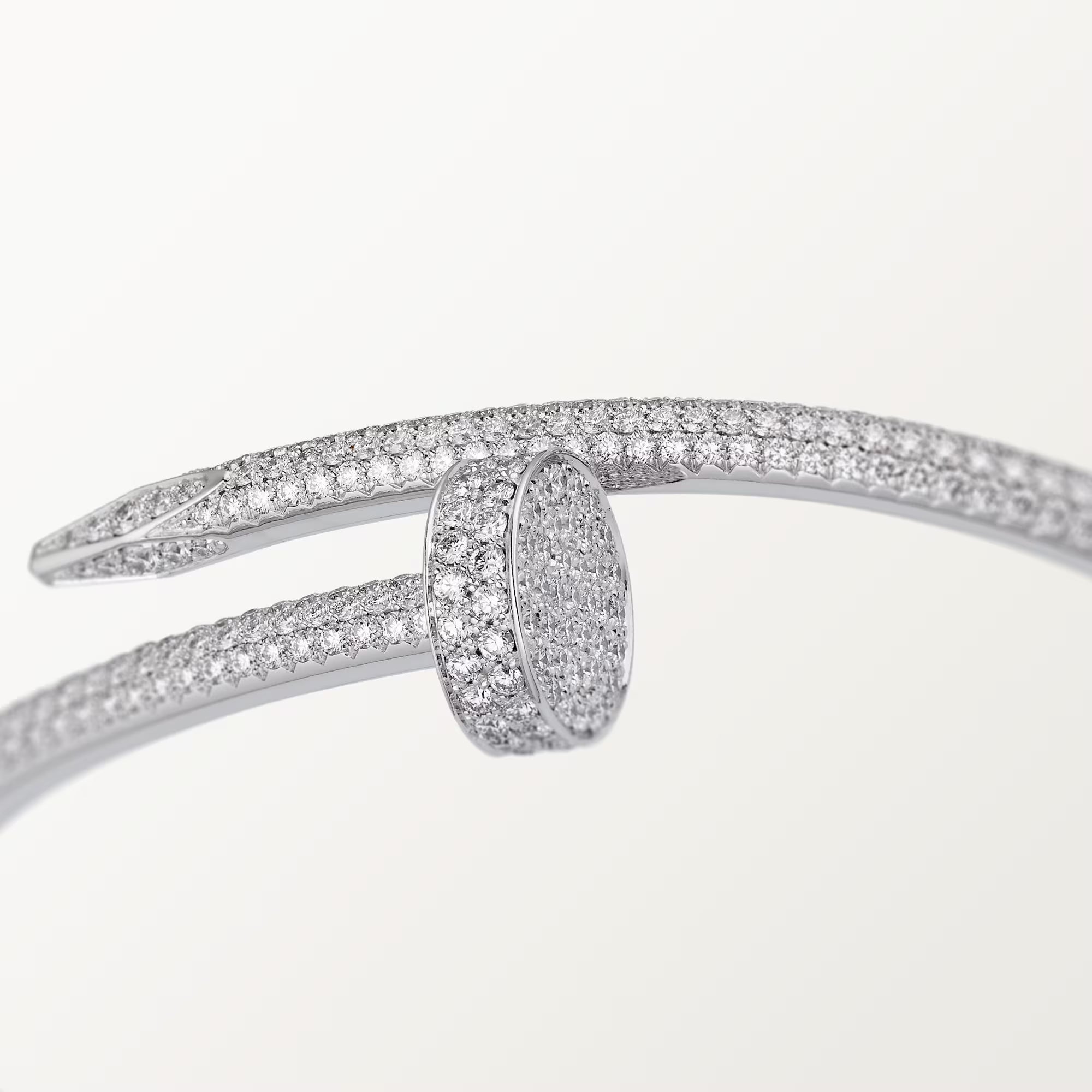 Silver bracelet with diamond accents on a light gray background