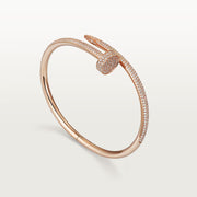 Rose gold bracelet with diamond accents on a light gray background