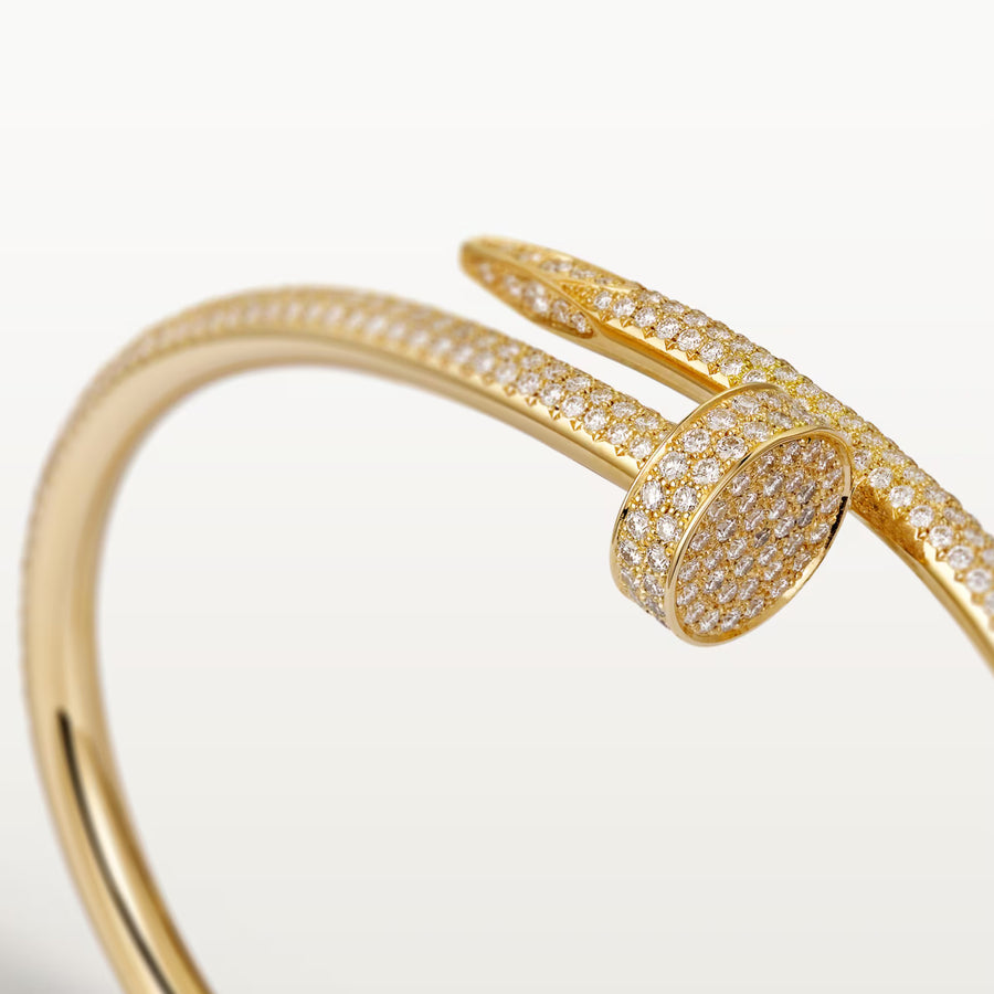 Gold bracelet with diamond accents on a light background