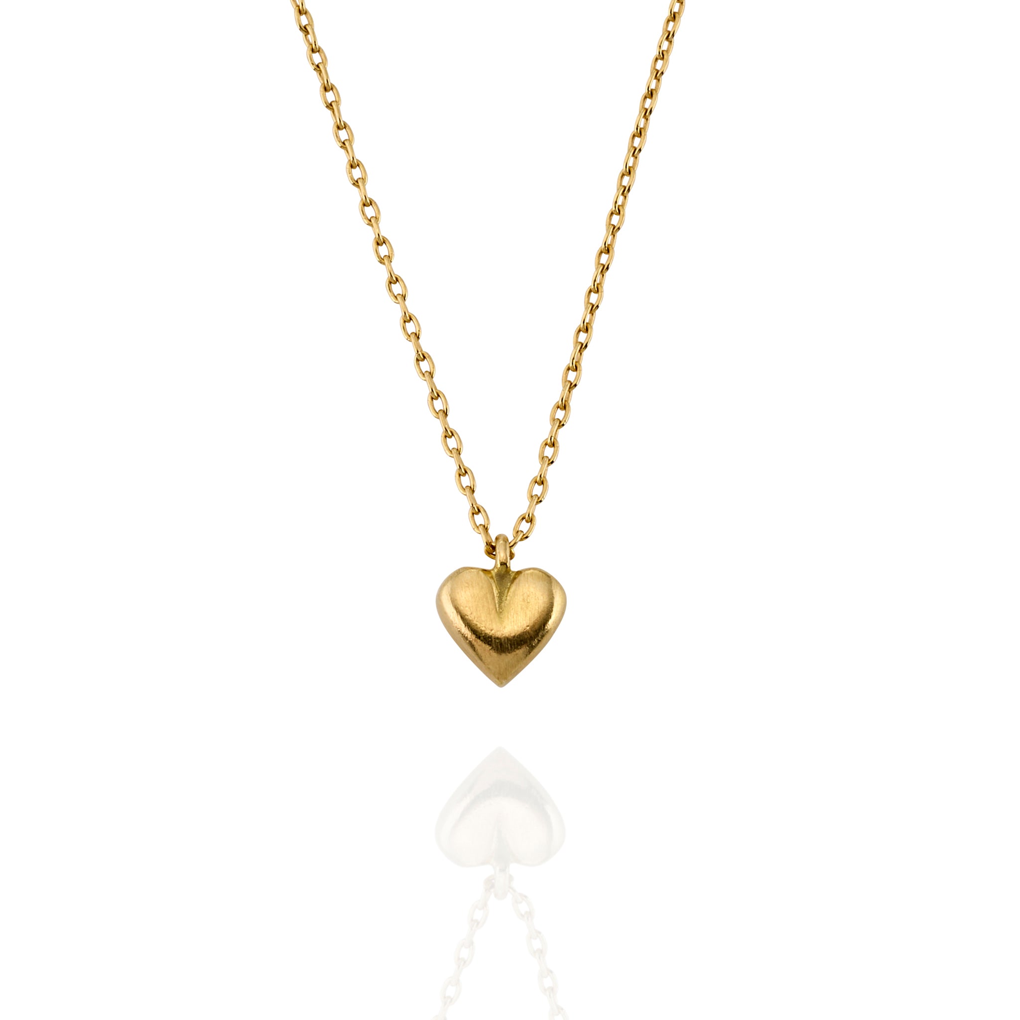 Close-up of a gold heart pendant on a fine chain, showing the brushed texture and soft curves of the charm.