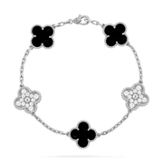 Overhead view of bracelet with alternating moissanite pavé and black onyx clover charms