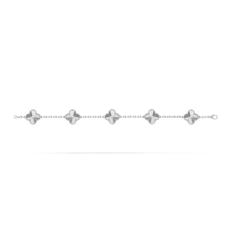 Silver bracelet with star-shaped charms on a white background
