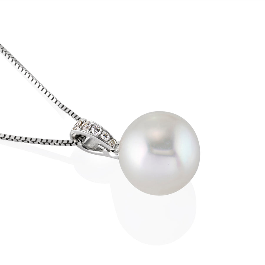 Close-up of a pearl drop pendant with moissanite-studded bail on a fine chain, displayed against a white background.