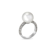 Angled view of pearl solitaire ring with moissanite pavé detailing along the band