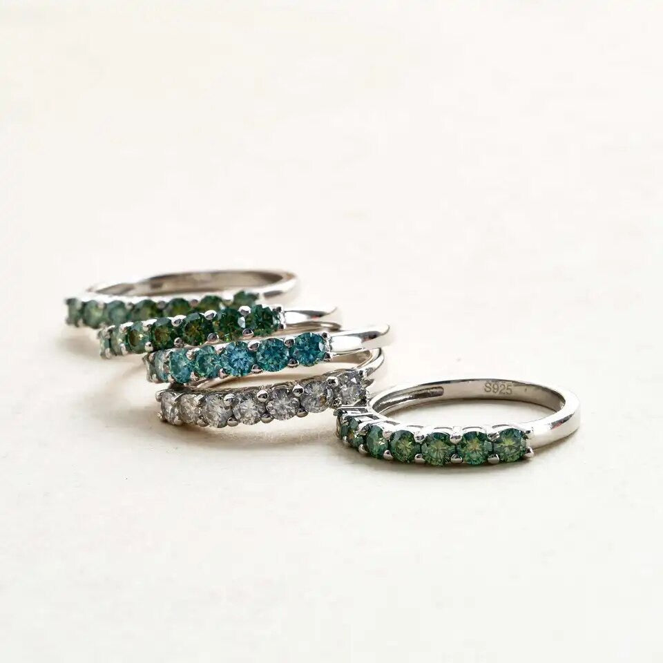 Flat lay of coloured Moissanite rings – full colour range display