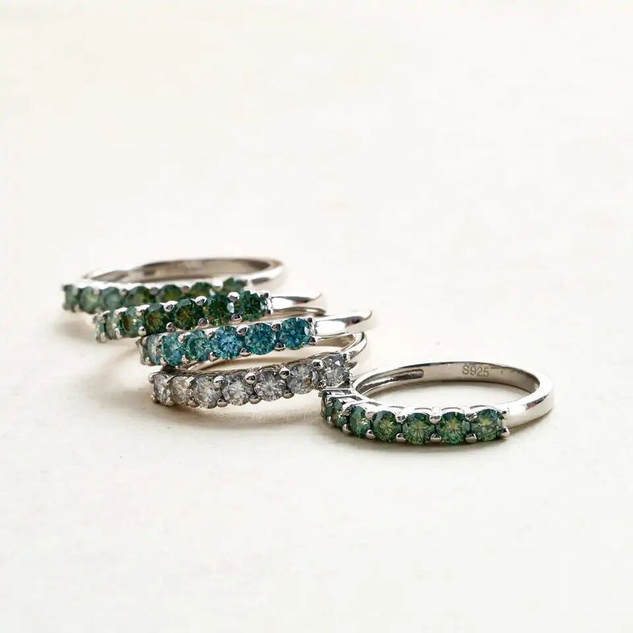 Flat lay of coloured Moissanite rings – full colour range display