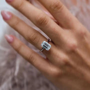 Diana ring worn on hand – elongated emerald cut with hidden halo