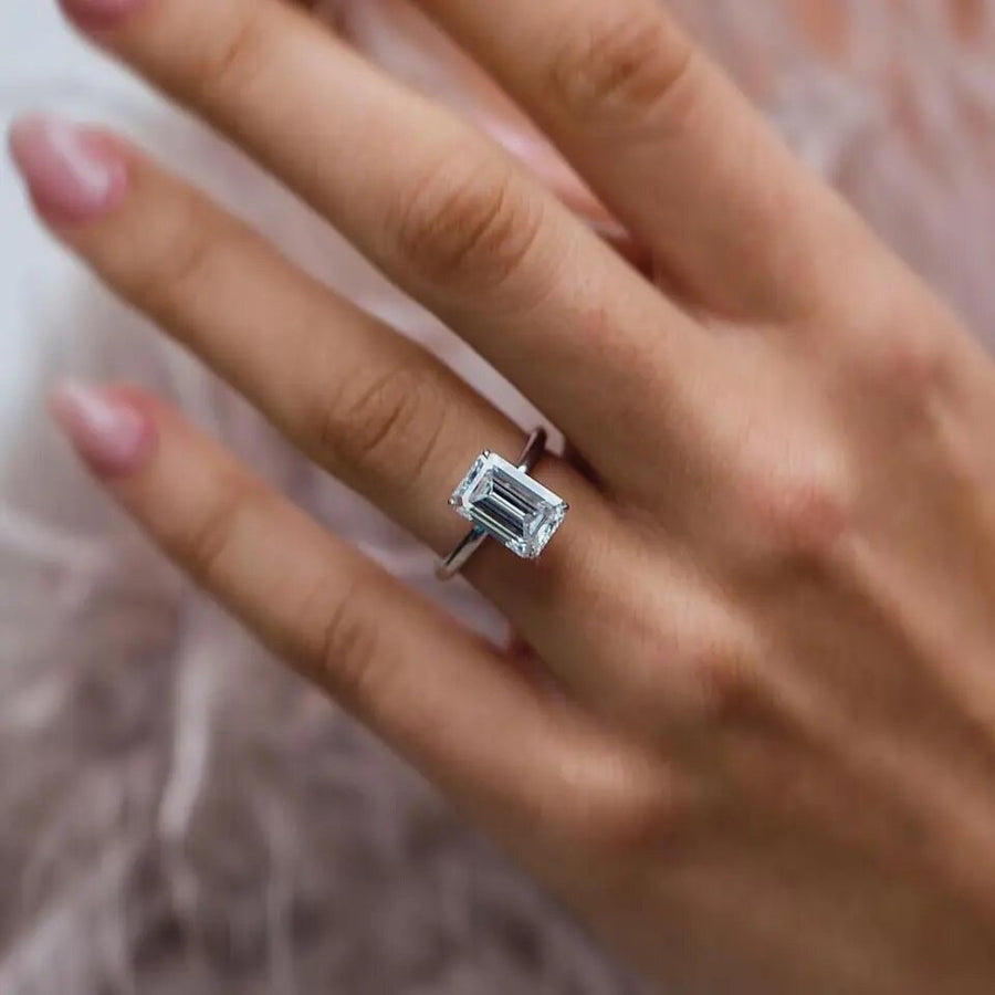 Diana ring worn on hand – elongated emerald cut with hidden halo
