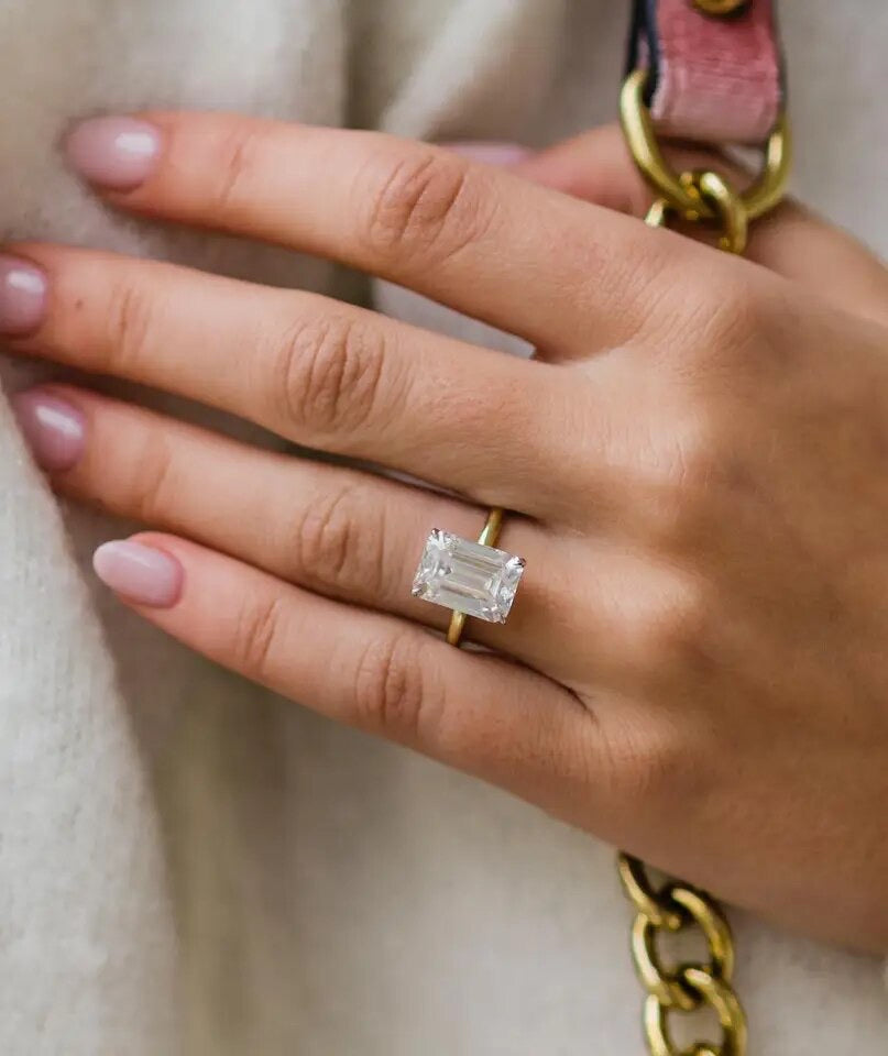 Faith ring worn on finger – elongated emerald centre stone
