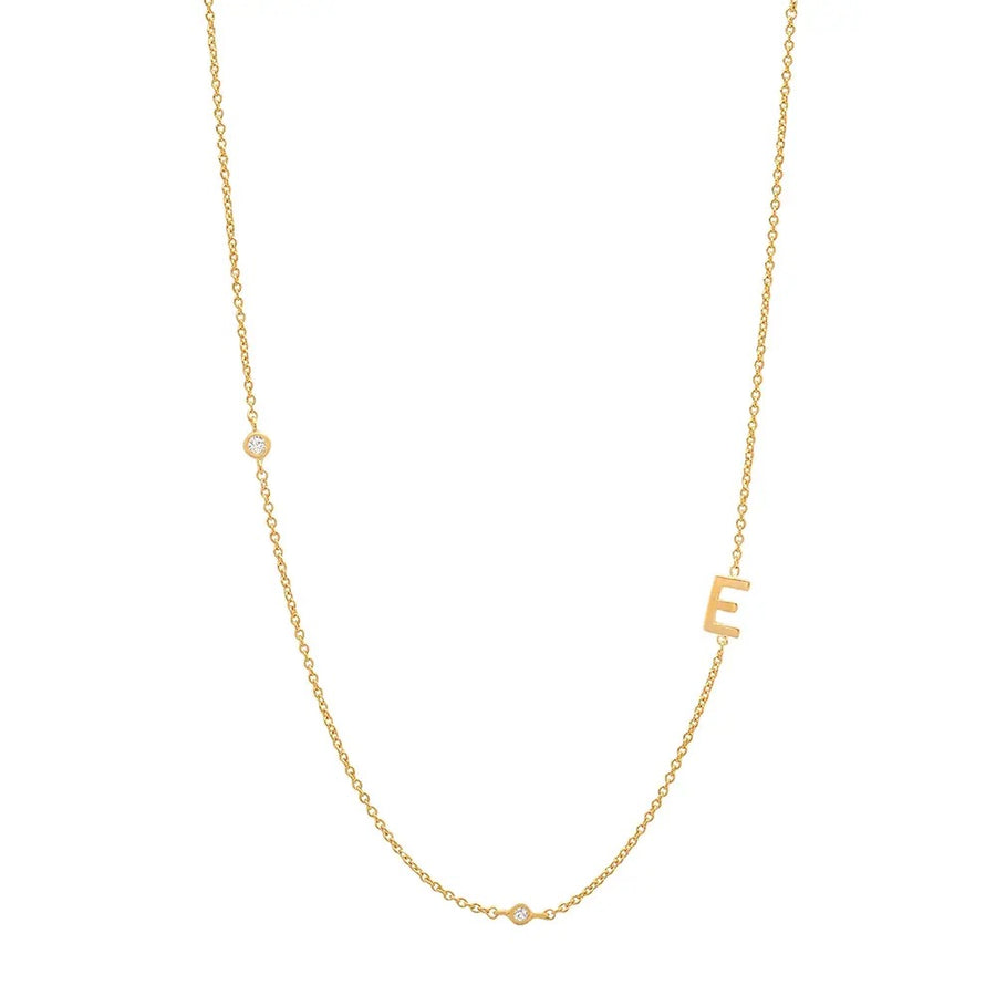 A gold vermeil necklace with a single letter 'E' pendant on a sterling silver chain.