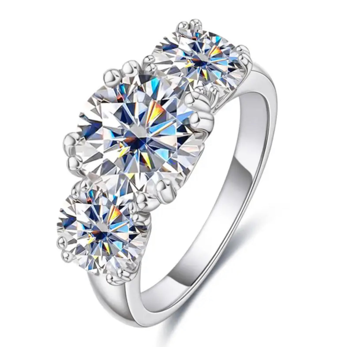 A trio of white moissanite stones set in a silver ring with a classic four claw setting.