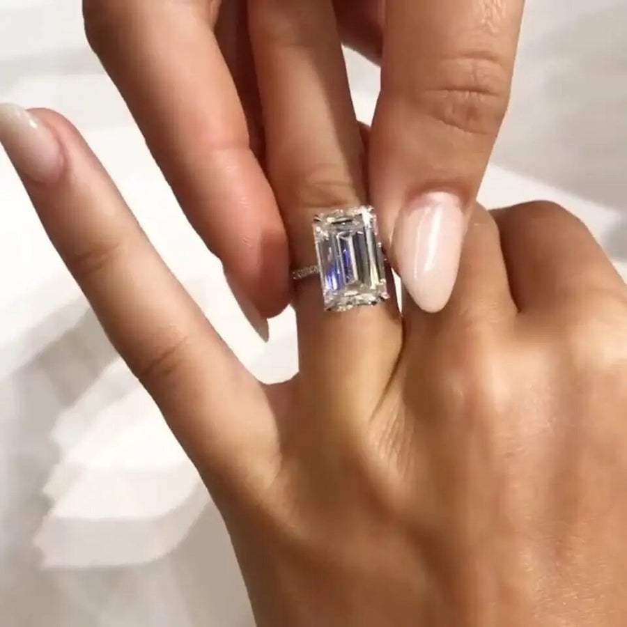 Sage emerald cut moissanite ring worn on hand with bold sparkle