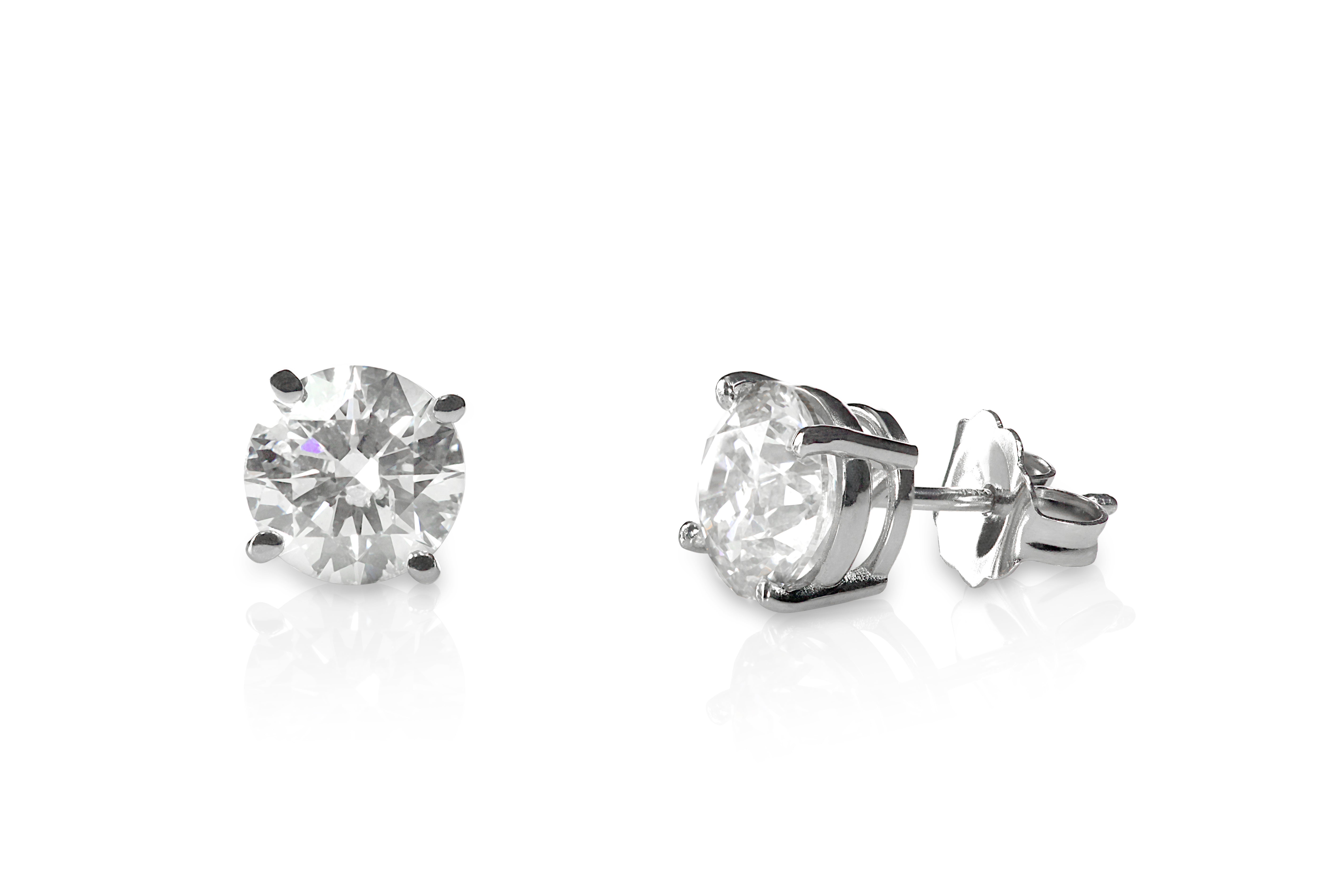 Pair of diamond stud earrings on a white background