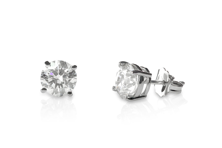 Pair of diamond stud earrings on a white background