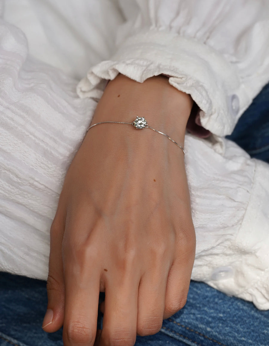 Dainty 1ct Moissanite bracelet in silver, shown on wrist for scale.