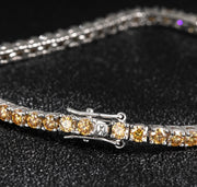 Close-up of 3mm Champagne Moissanite bracelet on black fabric