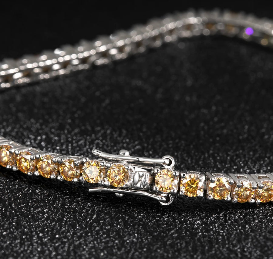 Close-up of 3mm Champagne Moissanite bracelet on black fabric