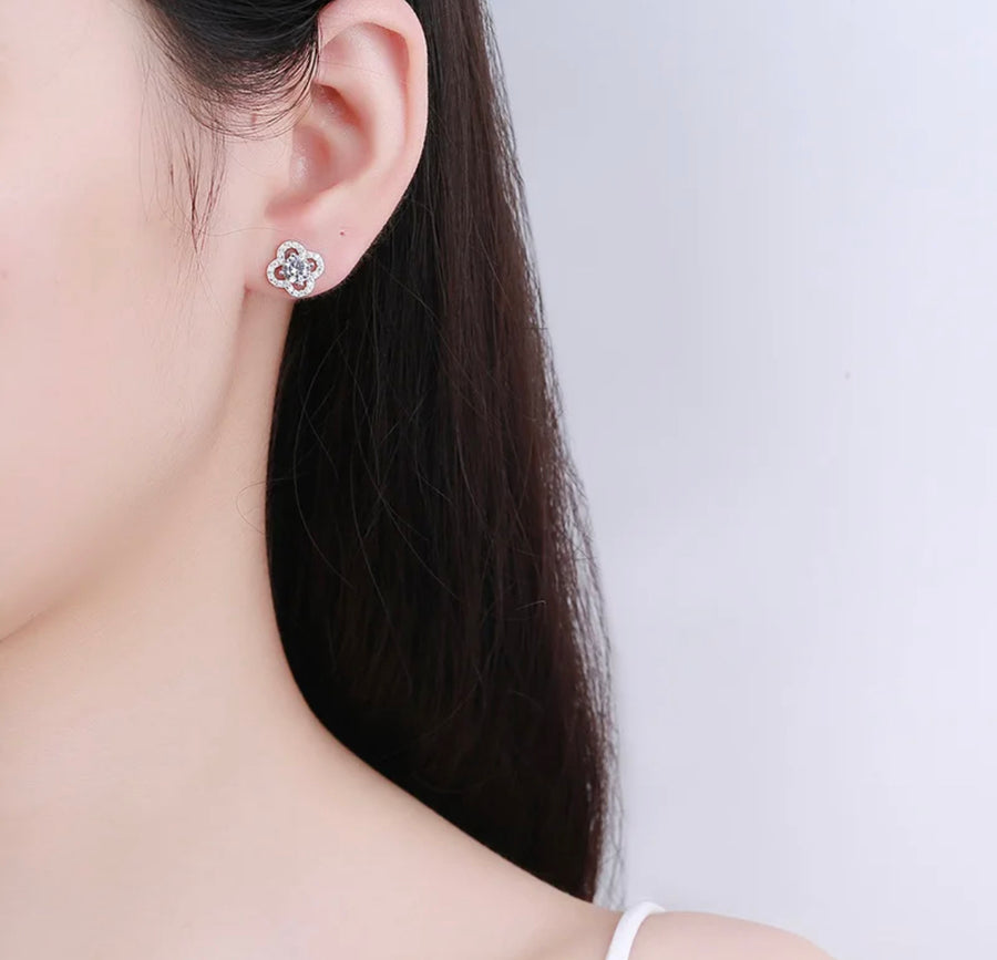 Clover studs worn on model ear – delicate and sparkly