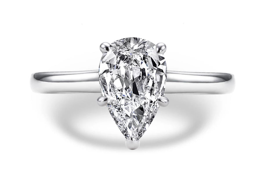 A tear-drop shaped Moissanite engagement ring with a hidden halo design, set in a white gold band.