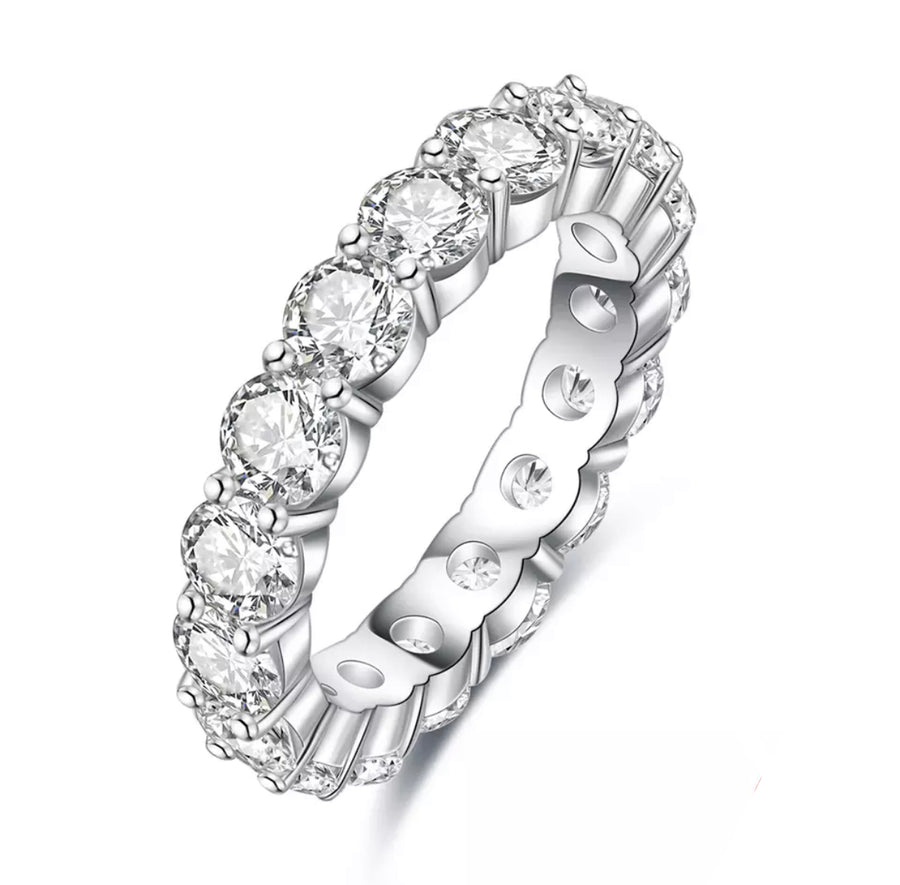 A silver-colored Moissanite stacking ring with multiple stones set around its circumference.