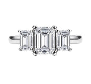 A silver-colored emerald cut moissanite ring with a VVS1 clarity grade.