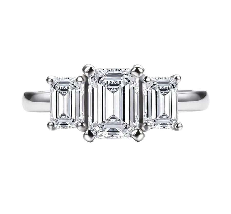 A silver-colored emerald cut moissanite ring with a VVS1 clarity grade.