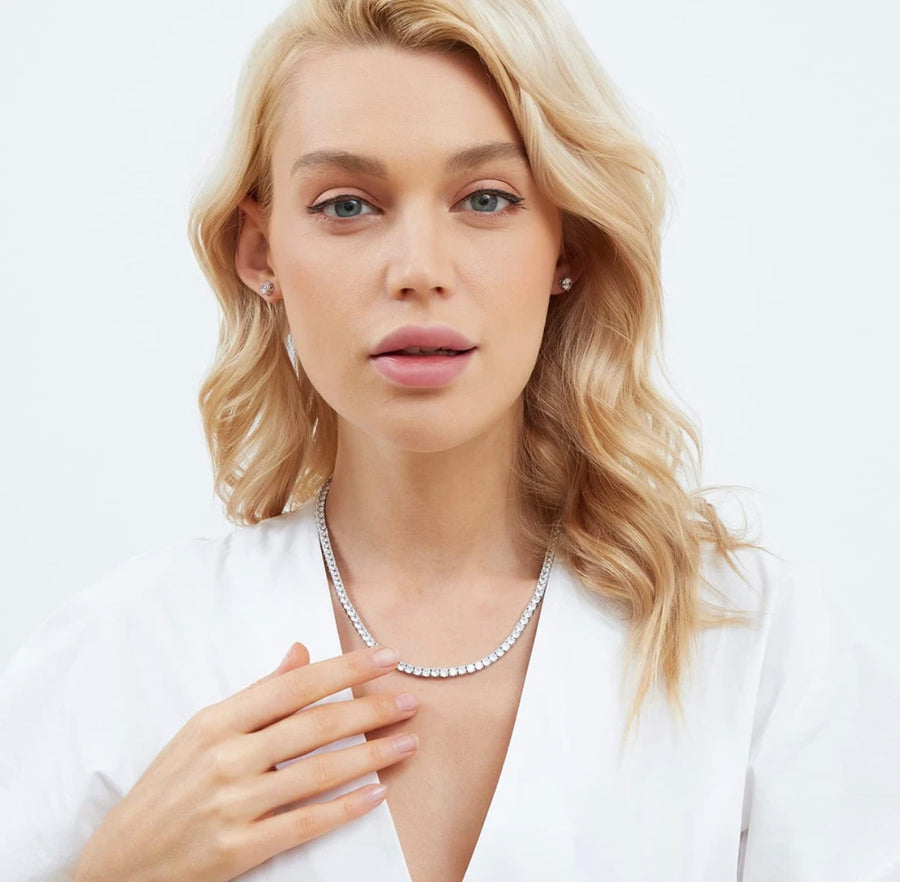 Model wearing Moissanite tennis necklace with white blouse