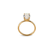 Side view of oval moissanite solitaire ring showing prong setting and polished yellow band