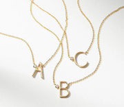 A gold vermeil necklace with large letters 'A', 'B', and 'C' on sterling silver chains.