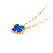 Gold necklace with a blue clover pendant on a black background