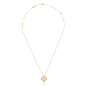 Gold necklace with a pendant on a black background