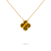 Gold necklace with a clover-shaped pendant on a black background